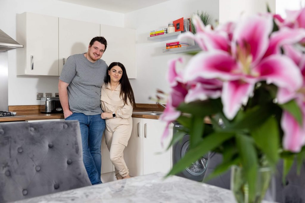 Shared ownership purchasers in their kitchen at Sycamore Gardens 