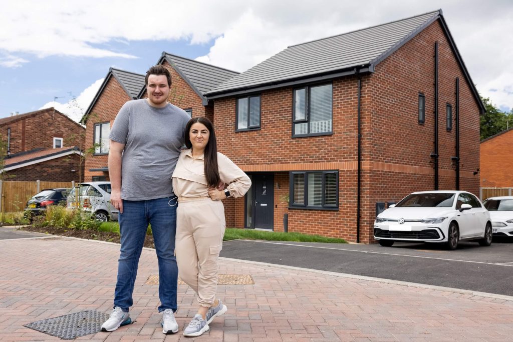 Shared ownership purchasers outside their home at Sycamore Gardens 