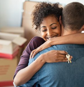 happy couple in new home on completion day