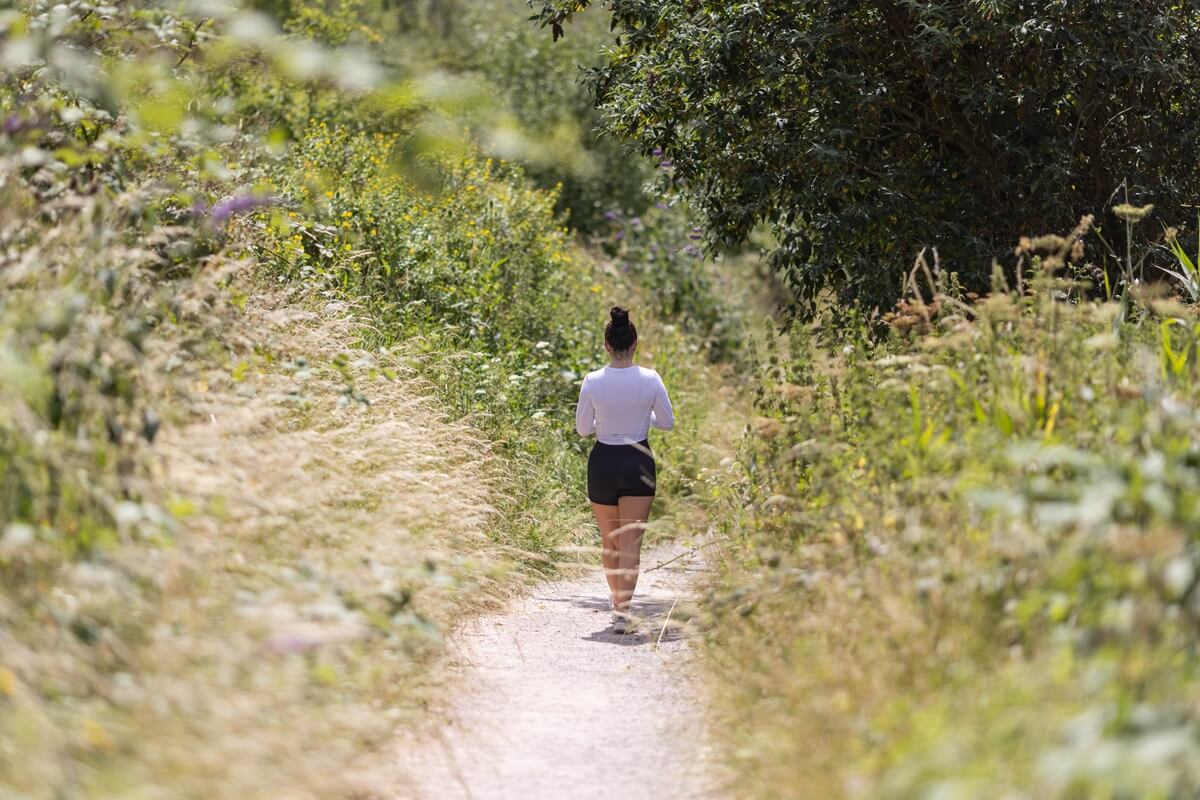 A girl walking through Port Sunlight River Park, next to Hamilton Waters, Port Sunlight